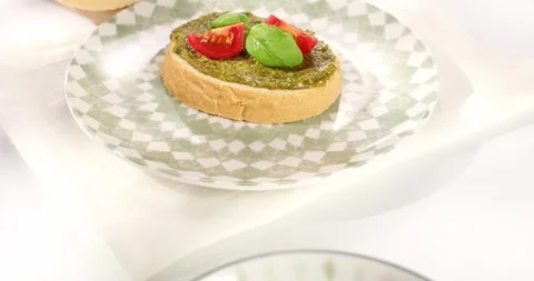 Pesto sauce in bowl and on bread. smooth camera movement. angle view. sunny day. Stock Footage 243773758