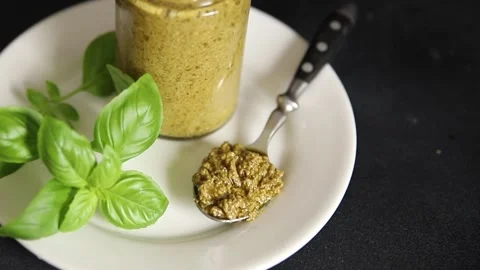 Pesto sauce green basil, olive oil, parmesan, pine nuts, garlic natural food Stock Footage 323223489