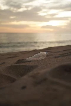 PET Plastic bottle trash on shore beach Stock Photos