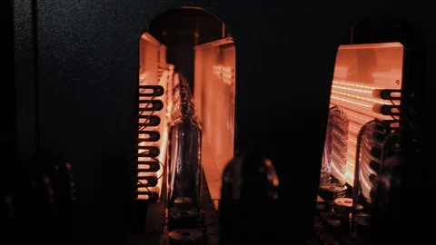 PET preforms move on heating oven line in fast speed. Plastic bottles production Stock Footage 105976152