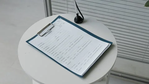 Pet Registration Form on Clipboard Lying on Table in Veterinary Clinic Stock Footage 339780980