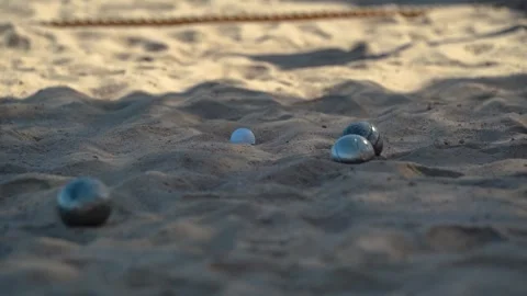 Petanque balls on a sandy beach Stock Footage 296189294