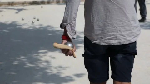 Petanque player shooting Stock Footage 75427910