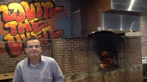 Pete Buttigieg introduced behind pizza counter Stock Footage 124266644