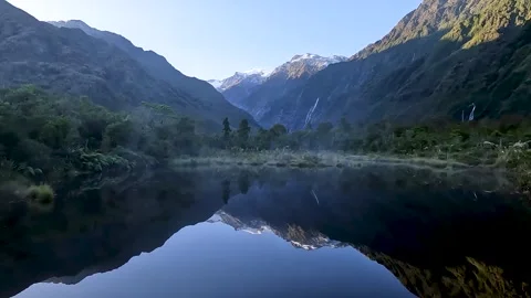 Peters Pool: A Reflective Glacial Mirror Lake with mountain and glacial val.. Stock Footage 289799493