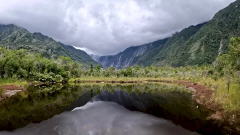 Peters Pool: A Reflective Glacial Mirror Lake with mountain and glacial val.. Stock Footage 289799513