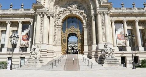 Petit Palais building, man passing on bike, clear blue sky in Paris, France. Stock Footage 124580988