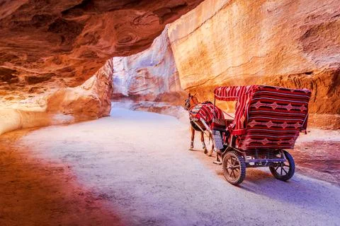 Petra, Jordan - Siq canyon and horse cart for tourists, Arabia. Stock Photos