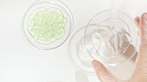 Petri dishes with cosmetics samples on a white background. Transparent Gel Fluid Stock Footage 169919652