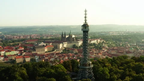 Petrin lookout tower rises on hill in Prague near historic castle landmark Stockbeeldmateriaal 341344862