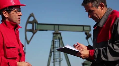 Petroleum Engineer Signing Documents at Oil Well Stock Footage 150736078