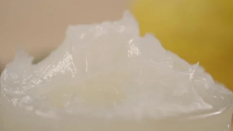 Petroleum jelly in a small container on yellow background Stock Footage 338320866