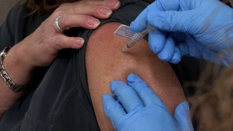 Pfizer BioNTech COVID 19 Vaccination Injected into recipient Stock Footage 145148988