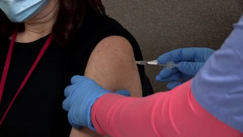 Pfizer BioNTech COVID 19 Vaccination injected into recipient Video stock 145150114