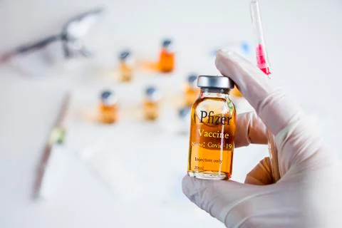 Pfizer Corona virus and Covid - 19 new vaccine in ampules and bottles, needle Stock Photos