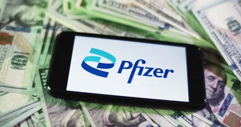 Pfizer Logo on iphone surrounded by $100 Bills. Pfizer Profits Layout. Stock Footage 169008326