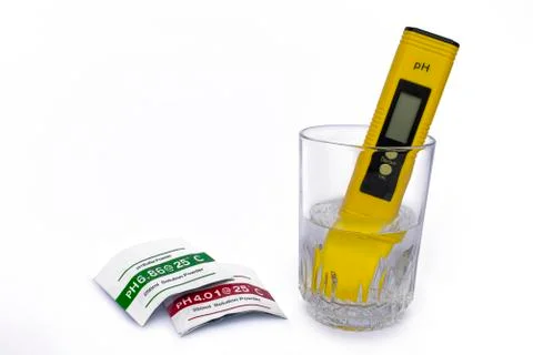 PH meter measuring the pH of the water in the glass Stock Photos