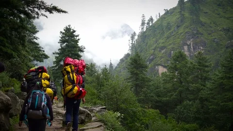 PHAKDING, NEPAL 11 SEPTEMBER 2017 : Trekkers Walking Pass The Green Cliff  ,  Stock Footage 84878519