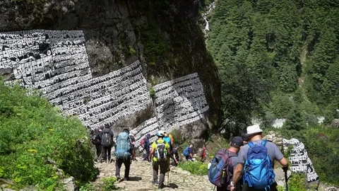 PHAKDING, NEPAL - 11 SEPTEMBER 2017 : Trekkers Walking Down Hill Passing Pray Stock Footage 84929248
