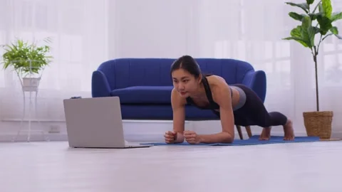 Phalankasana, Plank posture, working out, wearing sportswear, Asian woman pra Stock Footage 175626257