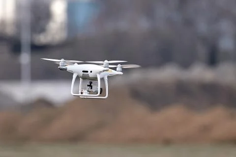Phantom 4 Pro drone in flight. Drone with damage from falls and radio beacon. Stock Photos