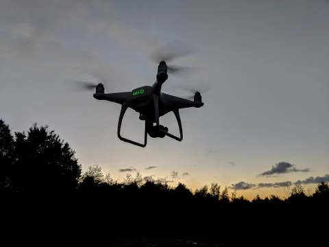 Phantom drone flying at sunrise Stock Photos