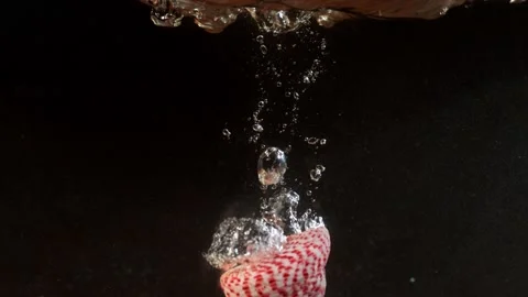 Phantom high speed shooting seashell falls into water Stock Footage 164253185