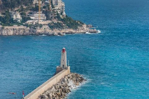 Phare de Nice (Lighthouse) as the waves smash into the pier of Port Lympia Stock Photos