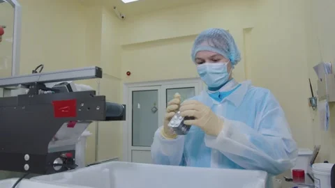 Pharma worker in protective mask and medical uniform examines and checks the Stock Footage 200855547