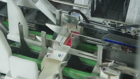 Pharmaceutical automated machinery forms the carton boxes with russian title Stock Footage 200856841