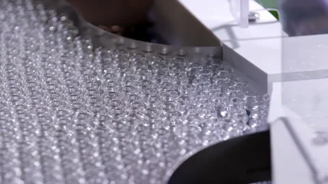 Pharmaceutical automatic vaccine injection mass production line on a conveyor Stock Footage 311807338