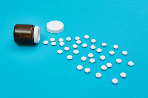 Pharmaceutical Industry and Medicinal Products - White Pills on Blue Background Stock Photos