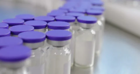 Pharmaceutical industry conveyor moving empty vial bottles Stock Footage 293094809