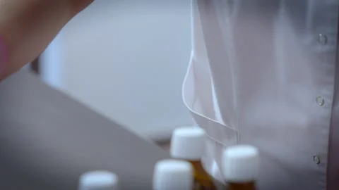 Pharmaceutical laboratory. Capping bottles of finished medicine. Medical concept Stock Footage 238507610