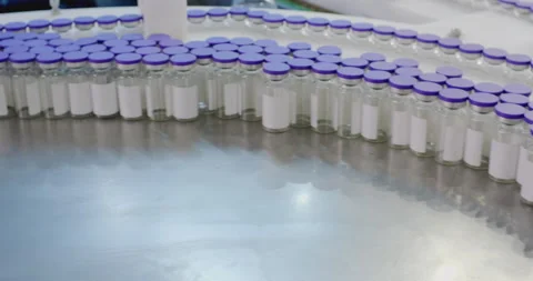 Pharmaceutical plant machine processing vials Stock Footage 293096001
