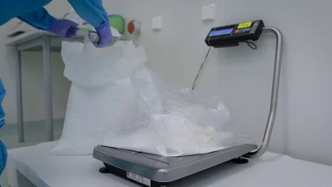 Pharmaceutical production. Working Party forms a chemical ingredient by weight Stock Footage 73729797