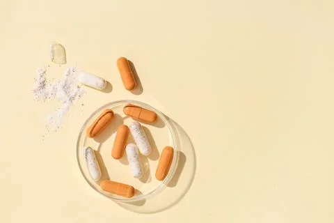 Pharmaceutical research and development with open capsule and powder on petri Stock Photos