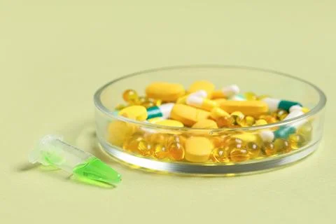 Pharmaceutical research and development with pills and liquid in petri dish a Stock Photos