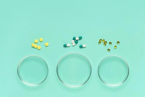 Pharmaceutical research and development with various pills and capsules on pe Stock Photos