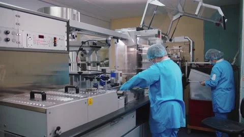 Pharmaceutical staff in protective masks and medical uniform examines and checks Stock Footage 200855600