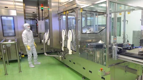 Pharmaceutical worker operating pharmaceutical equipment at pharmacy factory Stock Footage 83432019