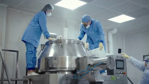 Pharmaceutical workers in protective masks and uniform work with medical Stock Footage 200856021