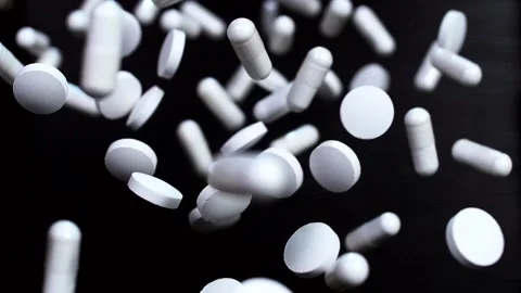 Pharmaceuticals on a black background in slow motion Stock Footage 141184664