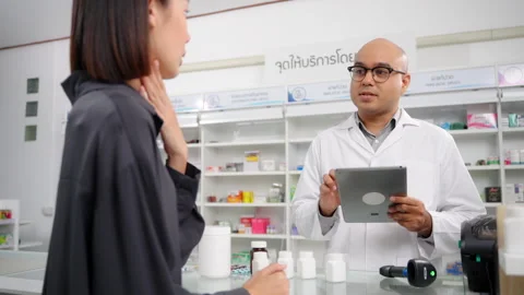 Pharmacist analyzing about customer symptoms for buying pill. Stock Footage 248039896
