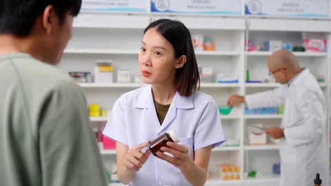 Pharmacist analyzing about customer symptoms for buying pill. Stock Footage 248040135