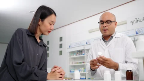 Pharmacist analyzing about customer symptoms for buying pill. 스톡 동영상 248769604