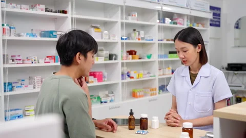 Pharmacist analyzing about customer symptoms for buying pill. Stock Footage 252552236