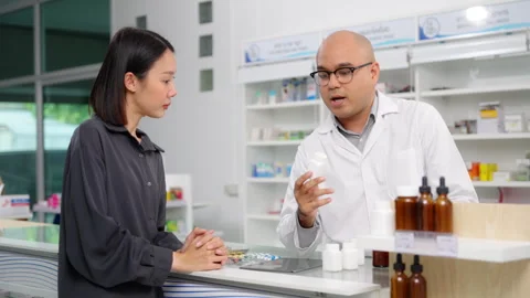 Pharmacist analyzing about customer symptoms for buying pill. Stock Footage 254707316