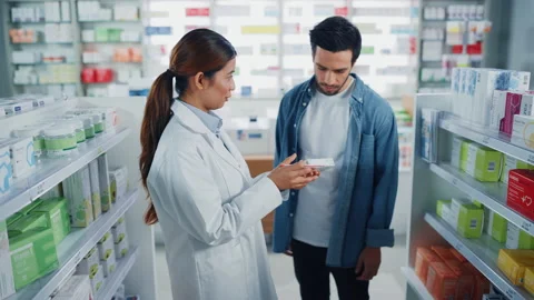 Pharmacist and Customer in Pharmacy Stock Footage 147211281