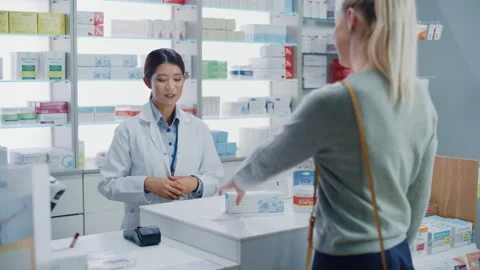 Pharmacist and Customer in Pharmacy Stock Footage 147223091